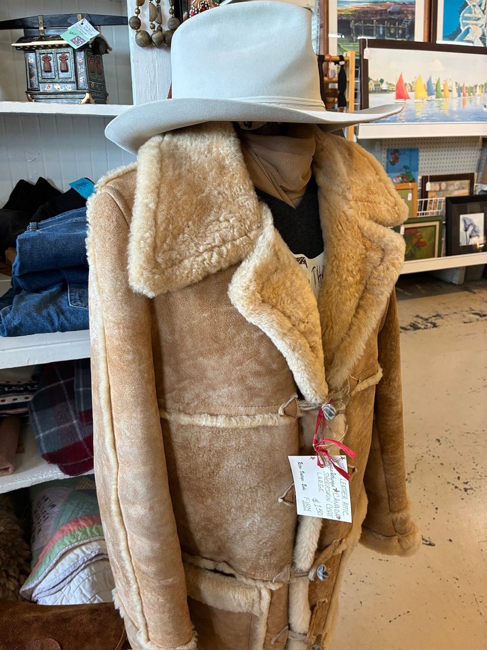 Tan shearling coat on a mannequin with a cowboy hat