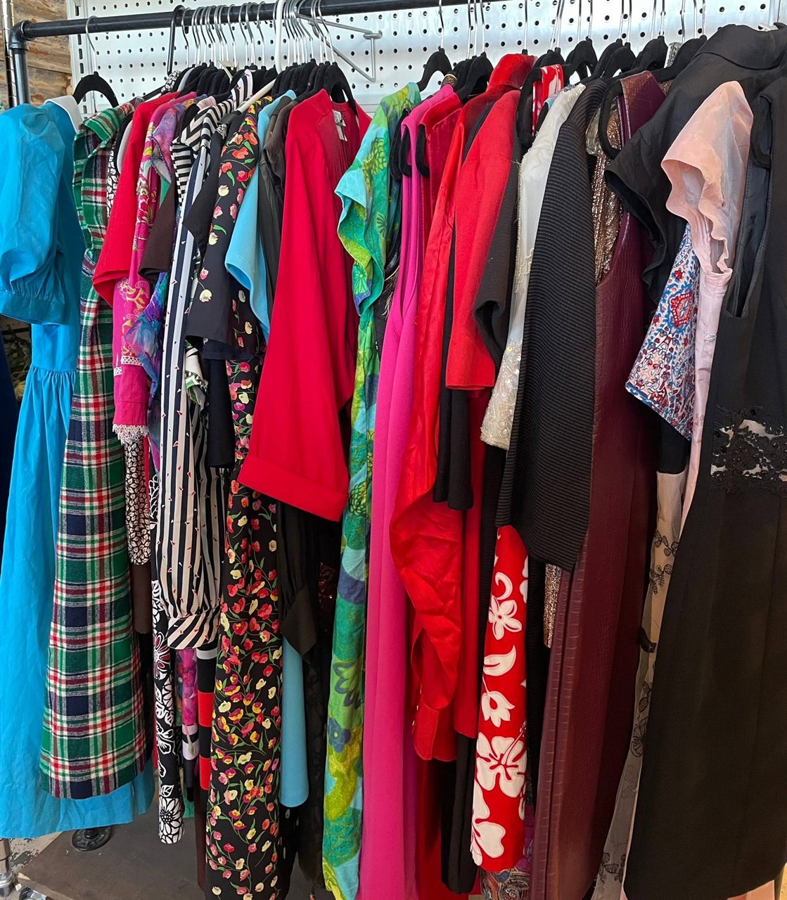 Rack of colorful vintage dresses and clothing