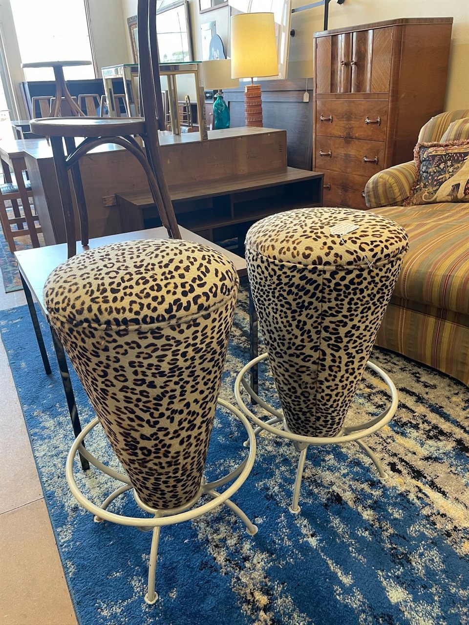 Pair of leopard print cone bar stools on white swivel bases