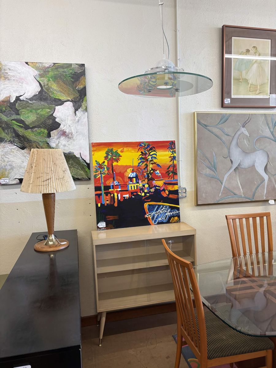Mid-century credenza with a colorful painting and deco wall art