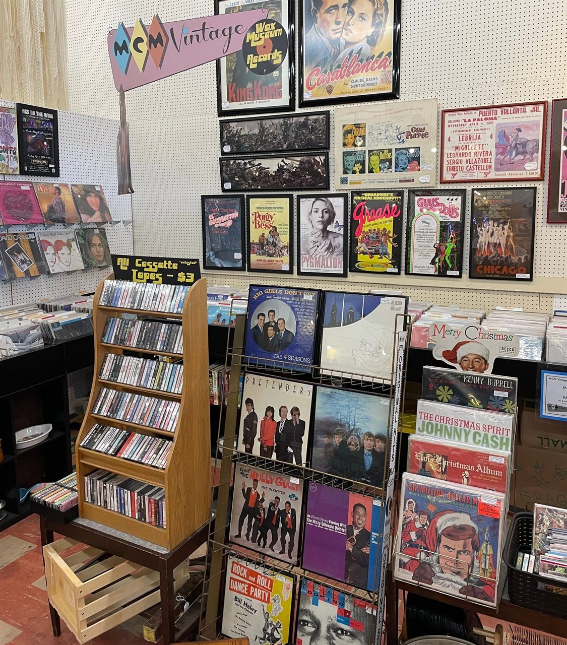 The Wax Museum Records and MCM Vintage corner with framed movie posters and bins of vinyl
